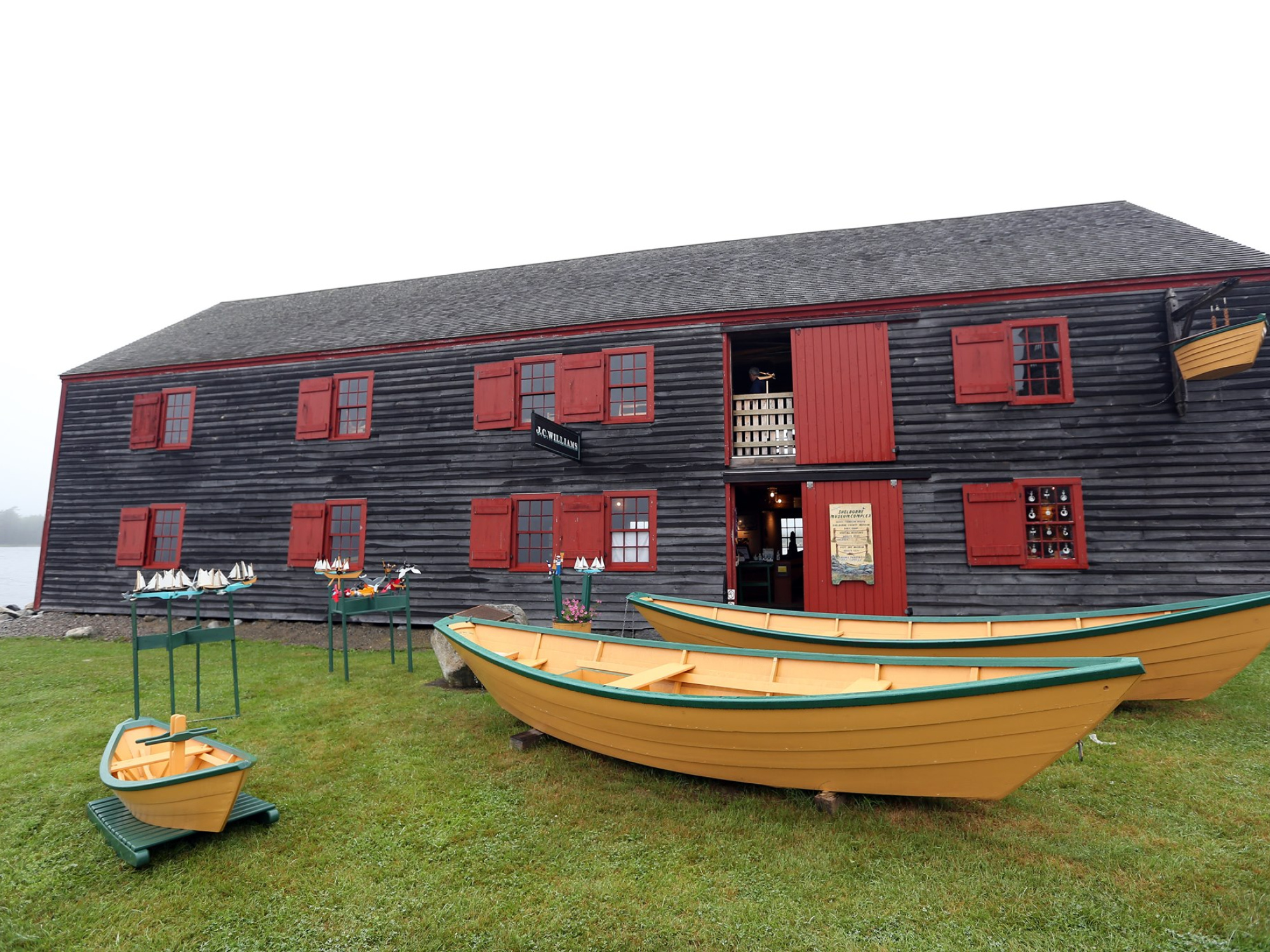 The Dory Shop Museum, a gray wooden building with red trim.